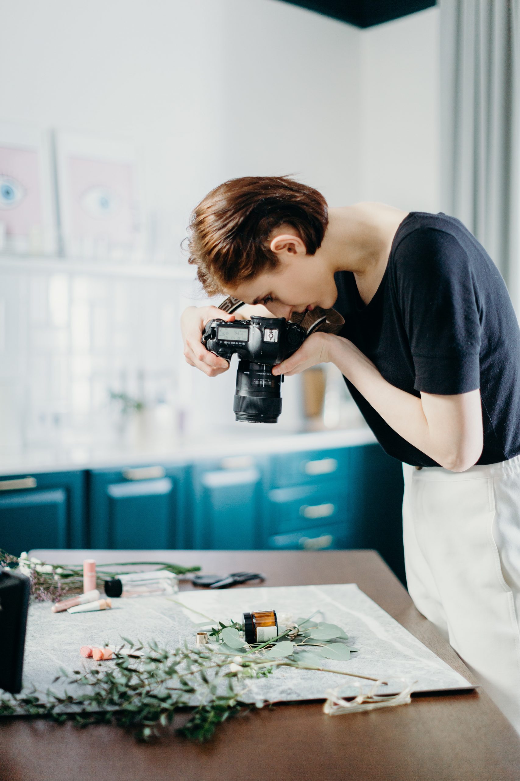 A photographer taking a beautifully staged overhead product shot
